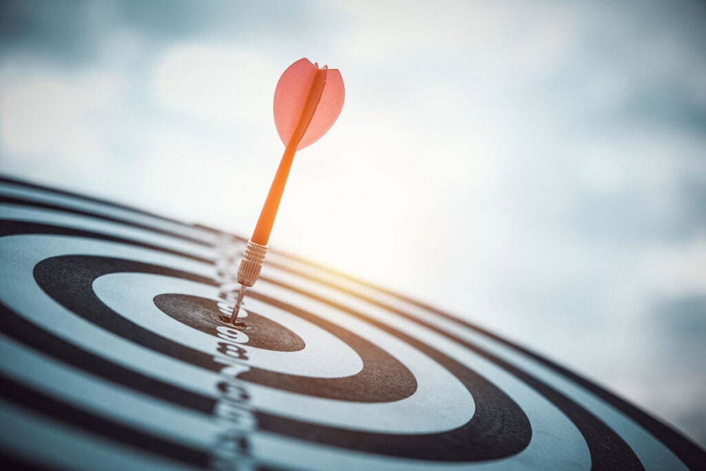 A dart hitting in the center of a target